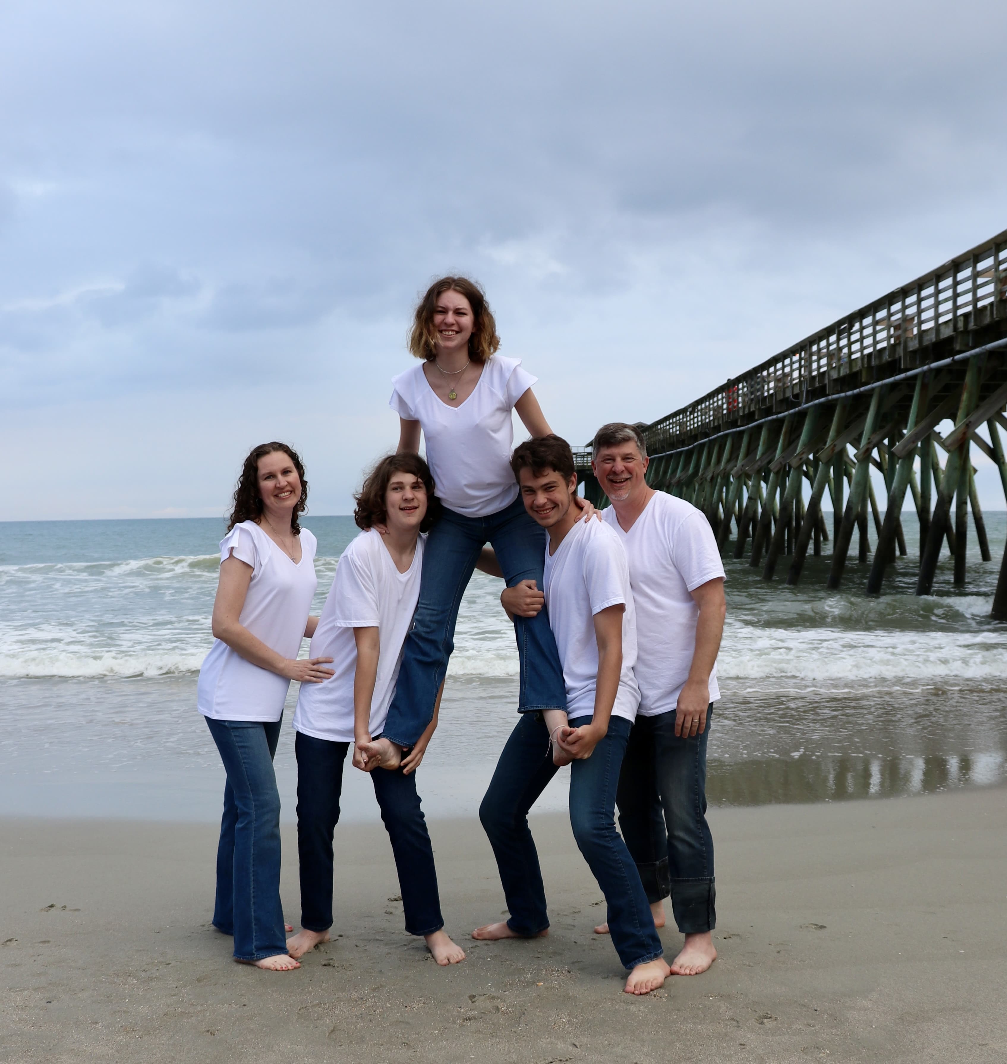 Dr. Brian Nardi on a beach with his wife Suanne and their three children Tony, Faith, and Ian